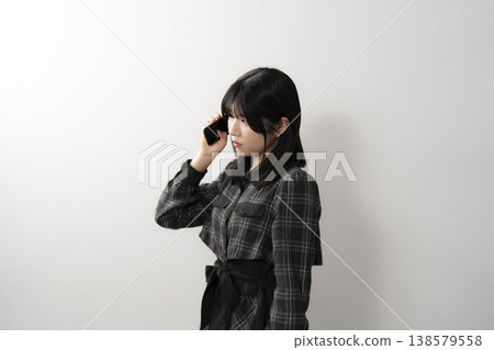 A woman using a mobile phone A woman using a mobile phone 138579558