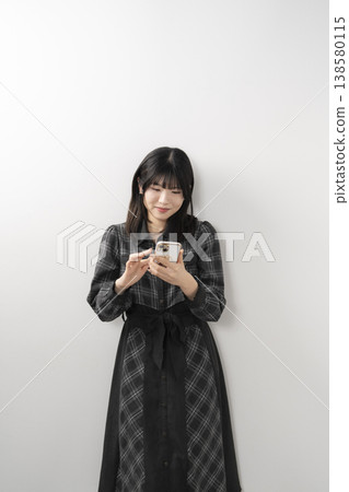 Woman using a smartphone Woman using a smartphone 138580115