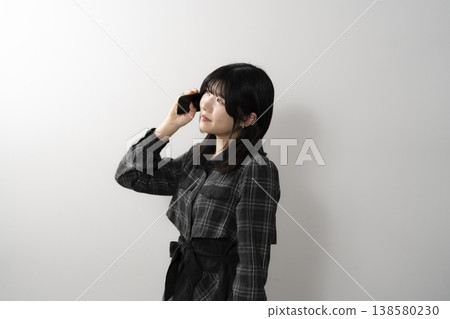 A woman using a mobile phone A woman using a mobile phone 138580230
