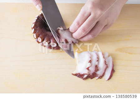 A scene of cutting an octopus with a knife. A scene of cutting an octopus with a knife. 138580539