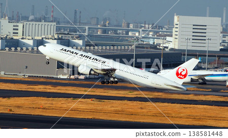 A full view of a JAL passenger plane taking off into the blue sky. A full view of a JAL passenger plane taking off into the blue sky. 138581448