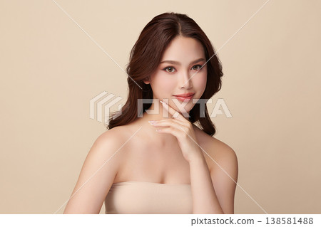A beautiful young Asian woman with clean, fresh skin against a beige background. Skincare, facial treatment, cosmetology, beauty, and spa. An elegant portrait of an Asian woman. A beautiful young Asian woman with clean, fresh skin against a beige background. Skincare, facial treatment, cosmetology, beauty, and spa. An elegant portrait of an Asian woman. 138581488