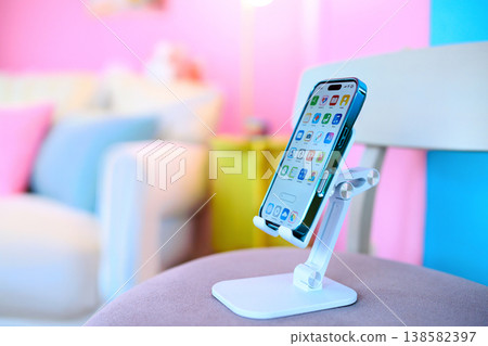 Smartphone placed on a smartphone stand: Happy Pop Smartphone placed on a smartphone stand: Happy Pop 138582397