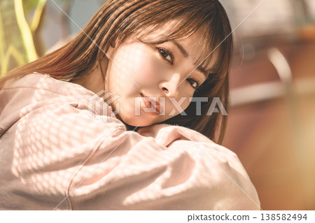 Face of a woman wearing a pink hoodie: Happy Pop Face of a woman wearing a pink hoodie: Happy Pop 138582494