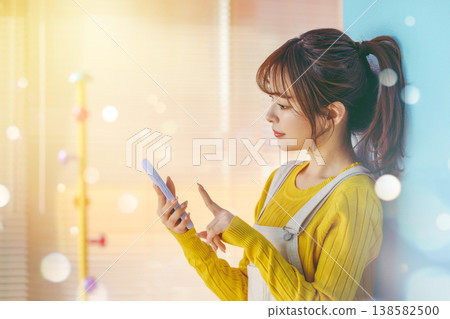 Young woman looking at her smartphone: Happy Pop Young woman looking at her smartphone: Happy Pop 138582500