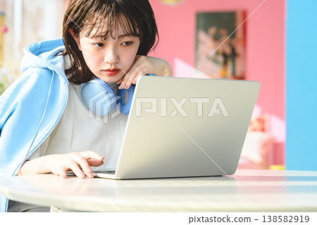 Female student working on her laptop: Happy Pop Female student working on her laptop: Happy Pop 138582919