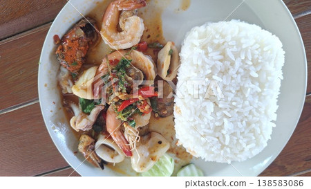 A delicious Thai street food dish of spicy stir-fried shrimp, squid, and mussels with holy basil. 138583086