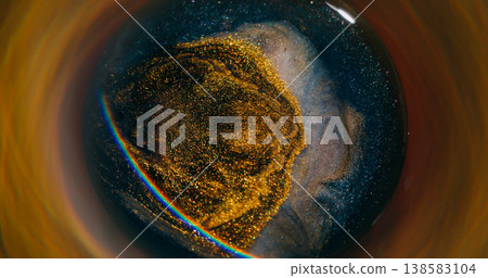 Blur golden splash. Light rainbow. Defocused bright yellow blue neon color ink glitter particles spatter circling on abstract background. Blur golden splash. Light rainbow. Defocused bright yellow blue neon color ink glitter particles spatter circling on abstract background. 138583104