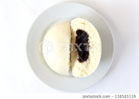 A sesame bean paste bun on a white background, viewed from directly above. A sesame bean paste bun on a white background, viewed from directly above. 138583119