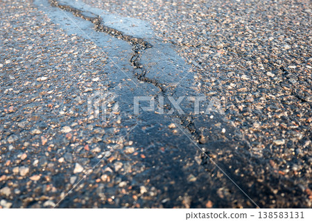 Cracked And Damaged Asphalt Pavement Affected By Weather And Deicing Salt Cracked And Damaged Asphalt Pavement Affected By Weather And Deicing Salt 138583131