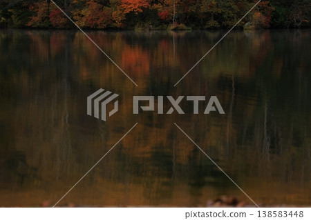 Autumn leaves reflected on the water Autumn leaves reflected on the water 138583448