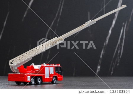 Fire truck - A fire truck that extends its ladder for operations (ladder truck). 138583594