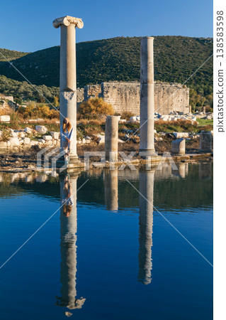 Ancient ruins of historical Patara city with old greek columns and sunny Mediterranean landscape with distant hills. Travel and adventure on summer Turkish holidays. Lycian way, Antalya, Turkey Ancient ruins of historical Patara city with old greek columns and sunny Mediterranean landscape with distant hills. Travel and adventure on summer Turkish holidays. Lycian way, Antalya, Turkey 138583598