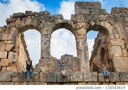 Happy family in Roman bath of ancient Greek city Tlos in Lycia located on Lycian way. Famous historical site In Antalya region. Popular place for family travel on summer vacation. Fethiye, Turkey Happy family in Roman bath of ancient Greek city Tlos in Lycia located on Lycian way. Famous historical site In Antalya region. Popular place for family travel on summer vacation. Fethiye, Turkey 138583614