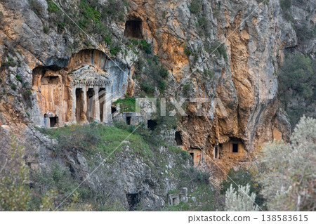Acropolis, tombs carved in rock of ancient Greek city Tlos in Lycia located on Lycian way. Famous historical site In Antalya region. Popular place for family travel on summer vacation. Fethiye, Turkey 138583615
