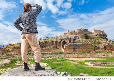 Happy tourist looks at ancient Greek city Tlos in Lycia located on Lycian way. Famous historical site In Antalya region. Popular place for family travel on summer vacation. Fethiye, Turkey 138583625