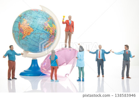 Miniature figures around a globe and a diamond in a studio setup during daylight celebrating Miniature figures around a globe and a diamond in a studio setup during daylight celebrating 138583946
