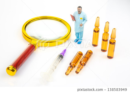 Miniature people with tools and equipment in a laboratory setting during daytime Miniature people with tools and equipment in a laboratory setting during daytime 138583949
