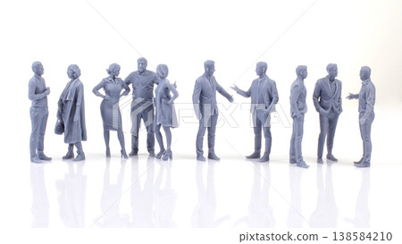 Miniature people stand in groups and talk in a studio setting as part of a display showcasing Miniature people stand in groups and talk in a studio setting as part of a display showcasing 138584210