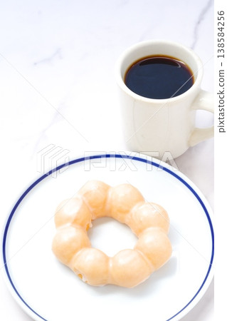 Take a break with a sweet donut and coffee. Take a break with a sweet donut and coffee. 138584256