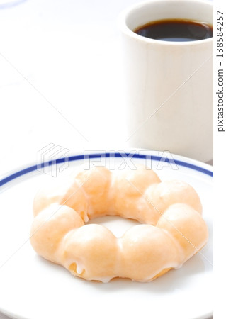 Take a break with a sweet donut and coffee. Take a break with a sweet donut and coffee. 138584257