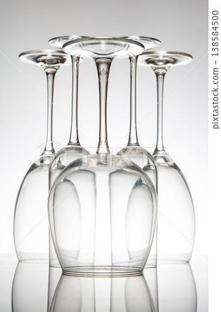 Glasses lined up in a creative arrangement on a reflective surface during studio light setup Glasses lined up in a creative arrangement on a reflective surface during studio light setup 138584500