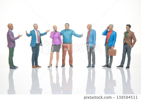 Miniature figurines of people engaging in conversation and interaction in a simple setting Miniature figurines of people engaging in conversation and interaction in a simple setting 138584511