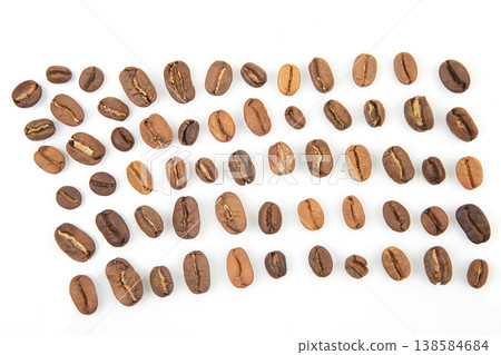 Different types of coffee beans arranged in neat rows on a white surface for display and comparison Different types of coffee beans arranged in neat rows on a white surface for display and comparison 138584684