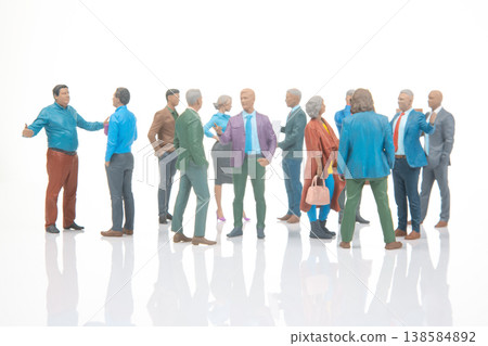 Miniature people gather for conversation and interaction in a bright setting with clear focus Miniature people gather for conversation and interaction in a bright setting with clear focus 138584892
