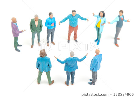 Group of miniature people in discussion on white background during a meeting around noon Group of miniature people in discussion on white background during a meeting around noon 138584906