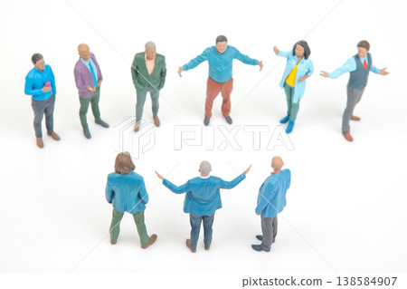 Miniature people gather for discussion in a circular formation during a meeting in a simple setting 138584907