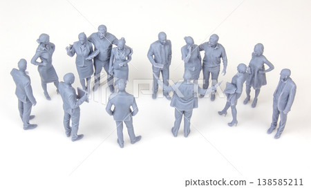 Miniature people gather in a circle, engaging in conversation at an unknown location during daytime Miniature people gather in a circle, engaging in conversation at an unknown location during daytime 138585211