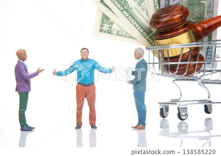 Miniature figurines in a negotiation over money and a cart in a simple setting with a gavel nearby Miniature figurines in a negotiation over money and a cart in a simple setting with a gavel nearby 138585220