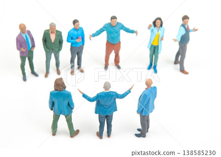 Miniature people gather and engage in conversation in a small group setting during daytime Miniature people gather and engage in conversation in a small group setting during daytime 138585230