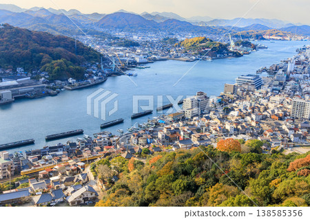 A yellow train on the Sanyo Main Line runs between Onomichi Strait and Koji Temple. A yellow train on the Sanyo Main Line runs between Onomichi Strait and Koji Temple. 138585356