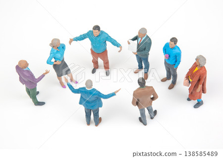 Group of people standing in a circle discussing ideas in a bright setting with white background 138585489