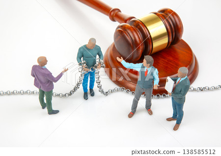 Figures in legal discussion with gavel and chained person in center showing courtroom scenario Figures in legal discussion with gavel and chained person in center showing courtroom scenario 138585512