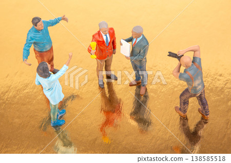 Small figures gather on a shiny surface to discuss a task in a creative setting during the day Small figures gather on a shiny surface to discuss a task in a creative setting during the day 138585518