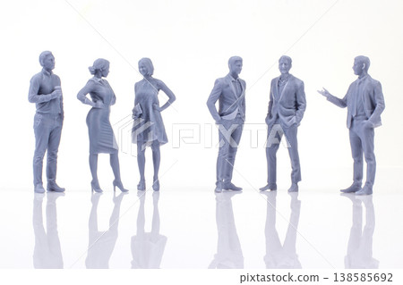 Miniature figurines of people standing and talking in a group during a gathering in a bright space Miniature figurines of people standing and talking in a group during a gathering in a bright space 138585692