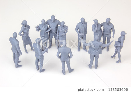 Miniature figurines of people in a group discussion at a meeting in a simple setting 138585696