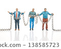 Miniature people hold chains in creative setup showcasing teamwork and cooperation in a unique scene 138585723