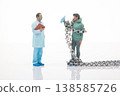 Miniature people interact with a chain and drink in a simple scene showing a meeting of a doctor  138585726