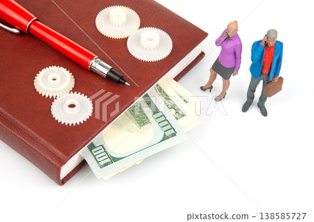 Miniature people talking near a book with money and gears on a white surface during daylight hours Miniature people talking near a book with money and gears on a white surface during daylight hours 138585727