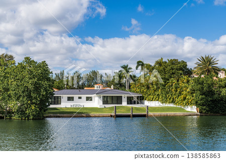 Luxury waterfront house. Hotel building architecture. Luxury lifestyle. Modern building. Residential apartment in waterfront city. City waterfront with house. Vacation building in summer Luxury waterfront house. Hotel building architecture. Luxury lifestyle. Modern building. Residential apartment in waterfront city. City waterfront with house. Vacation building in summer 138585863