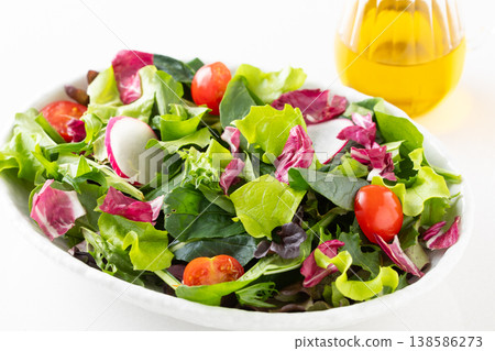 Vegetable salad and olive oil on the table 138586273