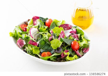 Vegetable salad and olive oil on the table 138586274