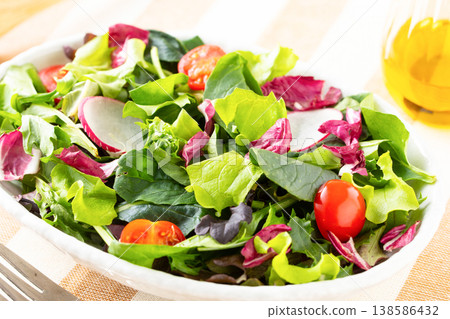 Vegetable salad and olive oil on the table Vegetable salad and olive oil on the table 138586432