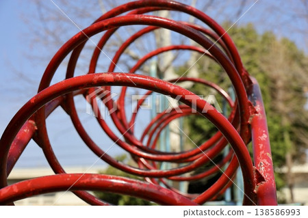 Red loop tunnel in the park, playground equipment 138586993