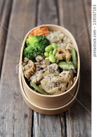 A healthy bento box in a traditional bento box, featuring mustard chicken and plenty of vegetables, with less than 500 calories. A healthy bento box in a traditional bento box, featuring mustard chicken and plenty of vegetables, with less than 500 calories. 138587163
