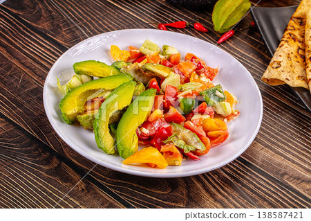 Healthy Avocado and Pepper Salad with Flatbread on a Rustic Wooden Table Healthy Avocado and Pepper Salad with Flatbread on a Rustic Wooden Table 138587421